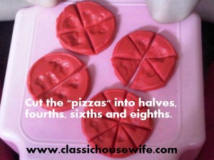 cutting the playdough pizzas with different numbers of slices